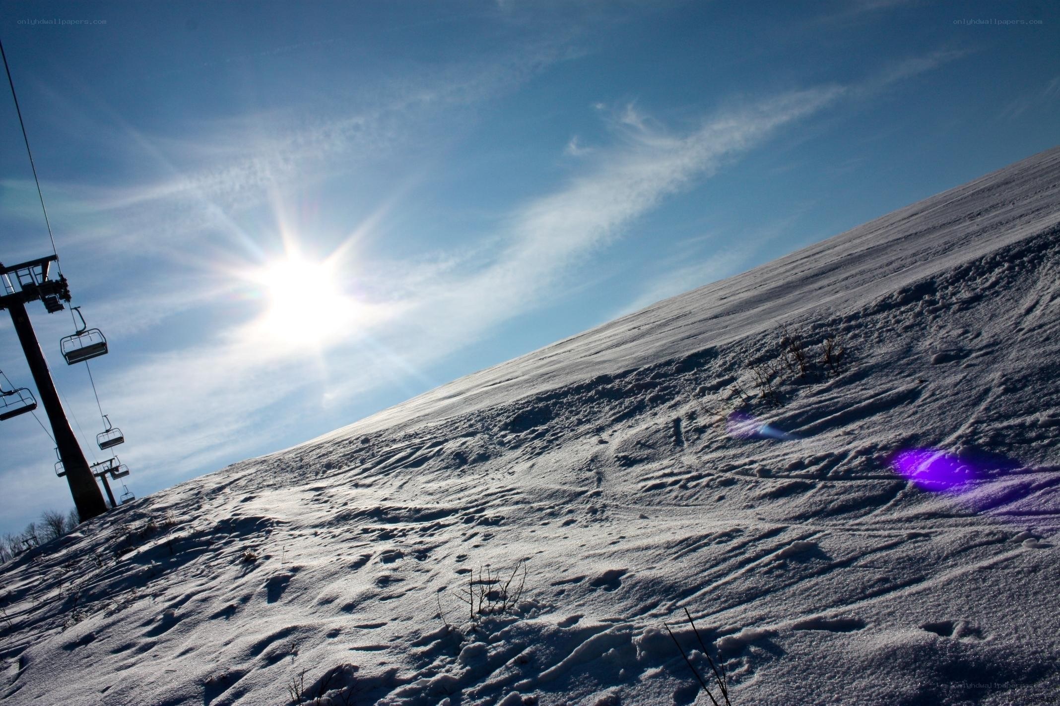 Sunlit ski slope with chairlift