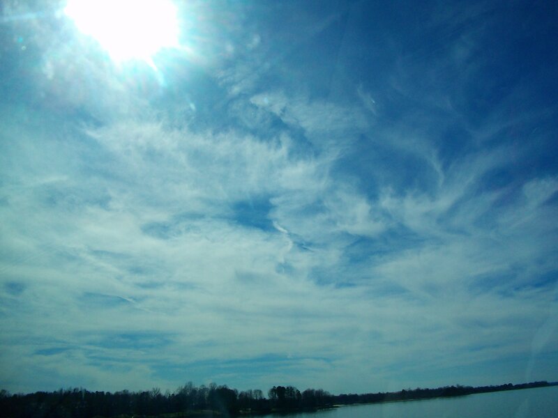 Sunlit sky over a lake