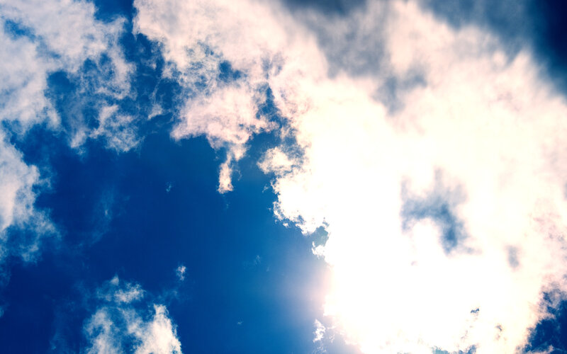 Sunlit sky with clouds