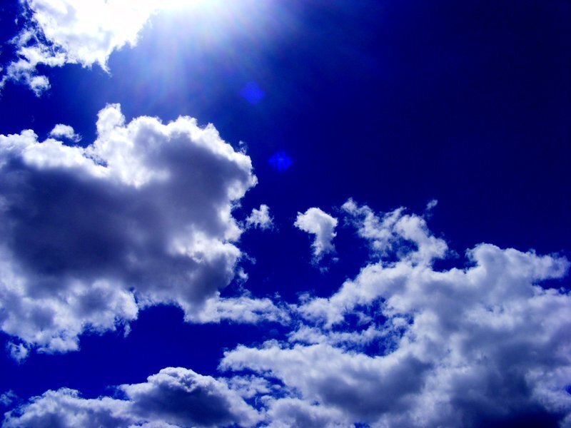 Sunlit sky with fluffy clouds
