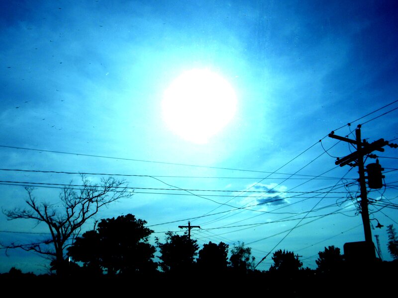 Sunlit sky with power lines