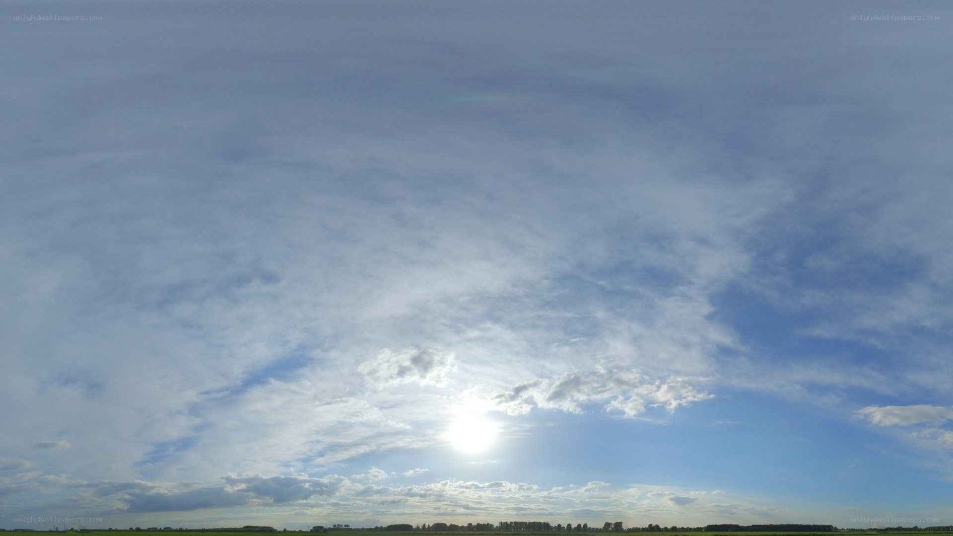 Sunlit sky with scattered clouds