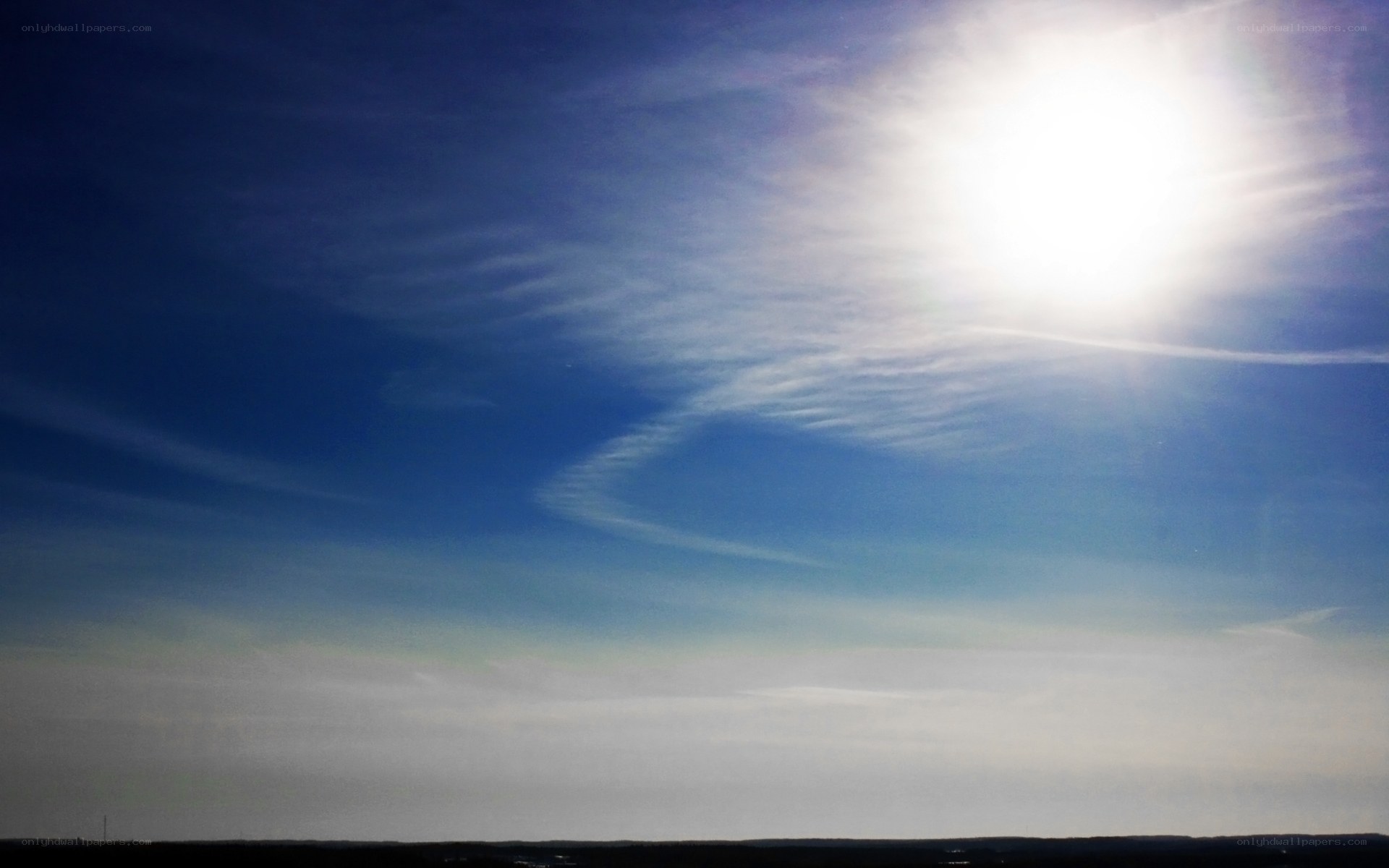 Sunlit sky with wispy clouds
