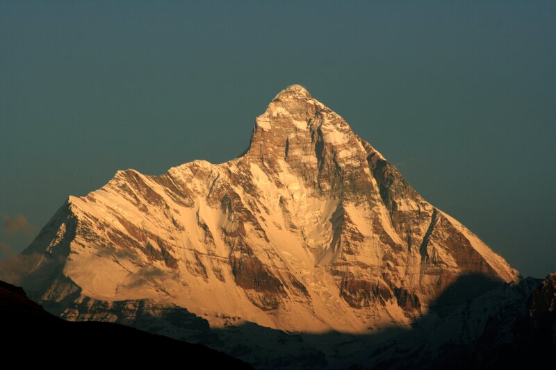 Sunlit snow-capped mountain peak