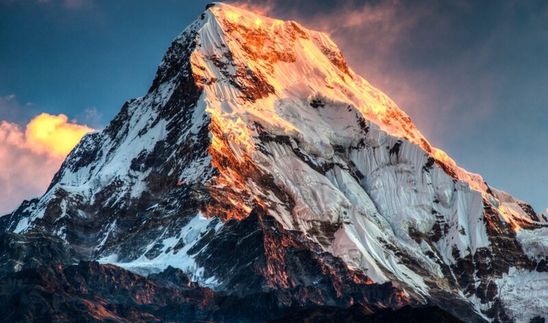 Sunlit snow-capped mountain peak