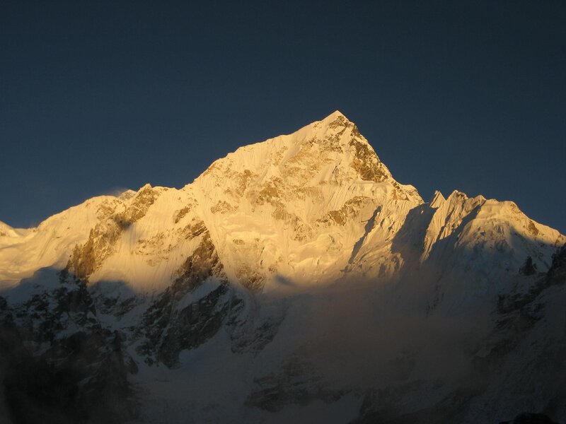 Sunlit snow-capped mountain peak