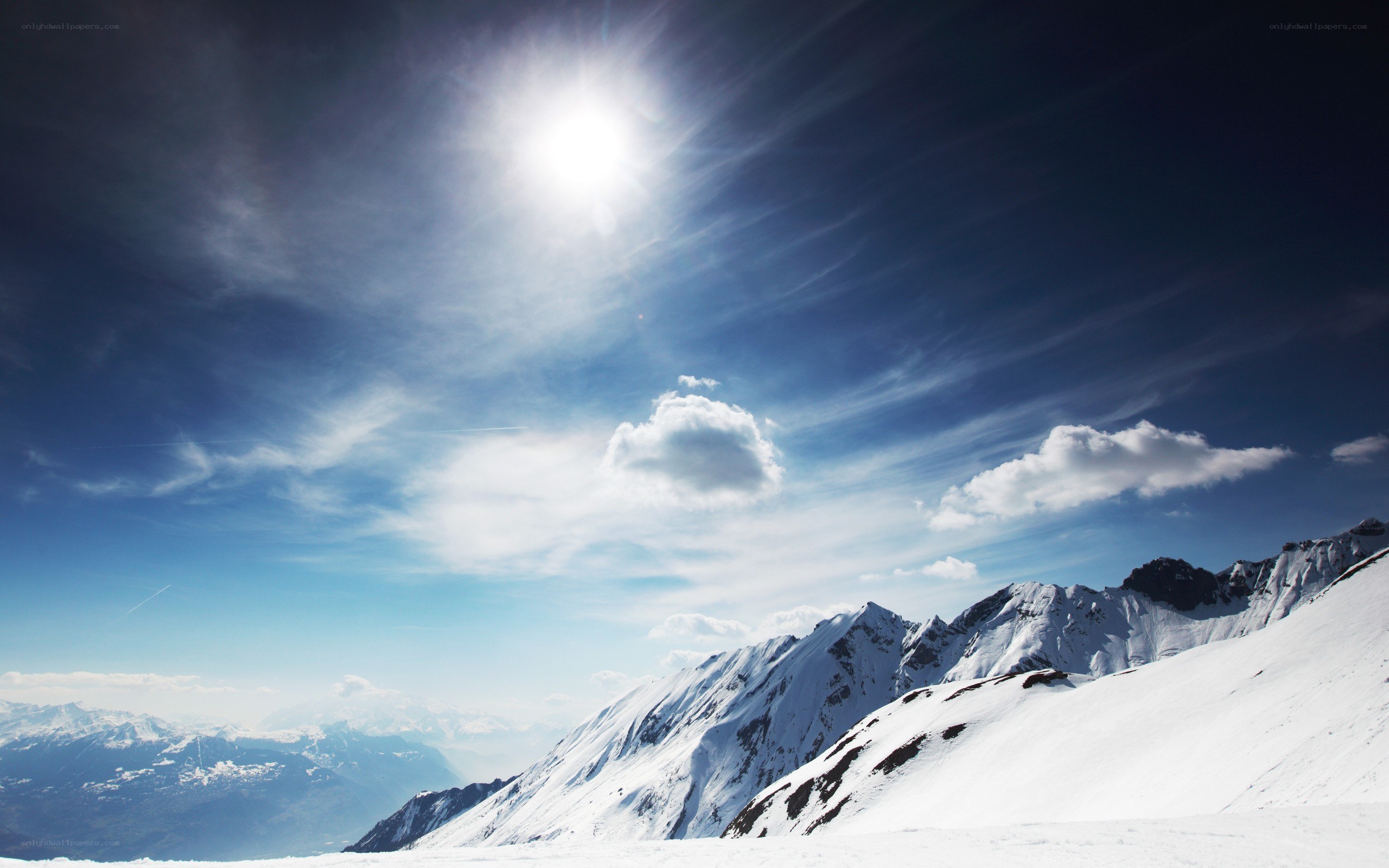 Sunlit snow-covered mountain peaks