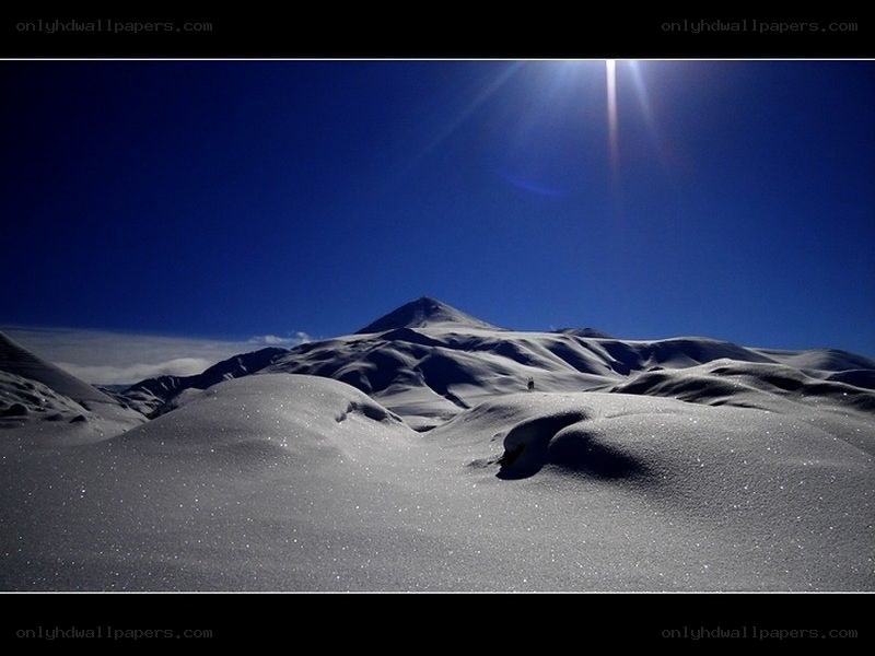 Sunlit snow-covered mountain peaks
