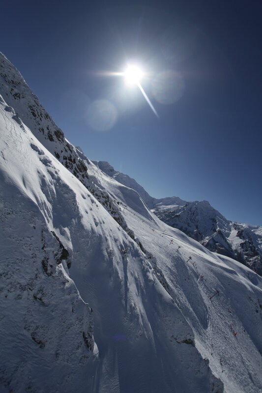 Sunlit snow-covered mountain slope