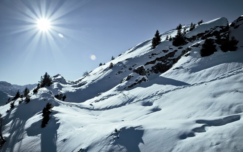 Sunlit snow-covered mountain slope