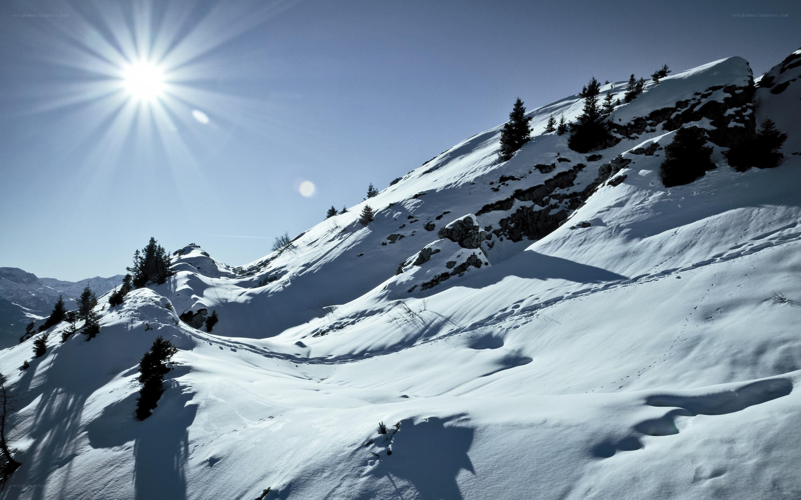 Sunlit snow-covered mountain slope
