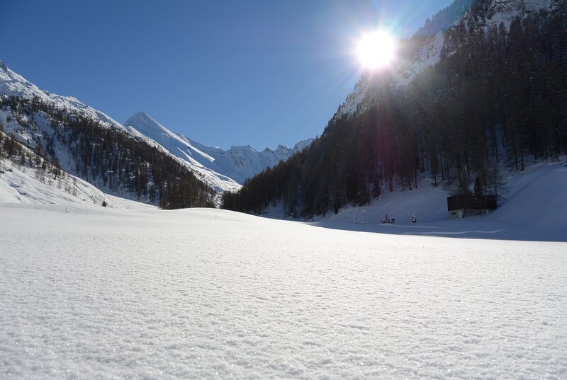 Sunlit snow-covered mountain valley