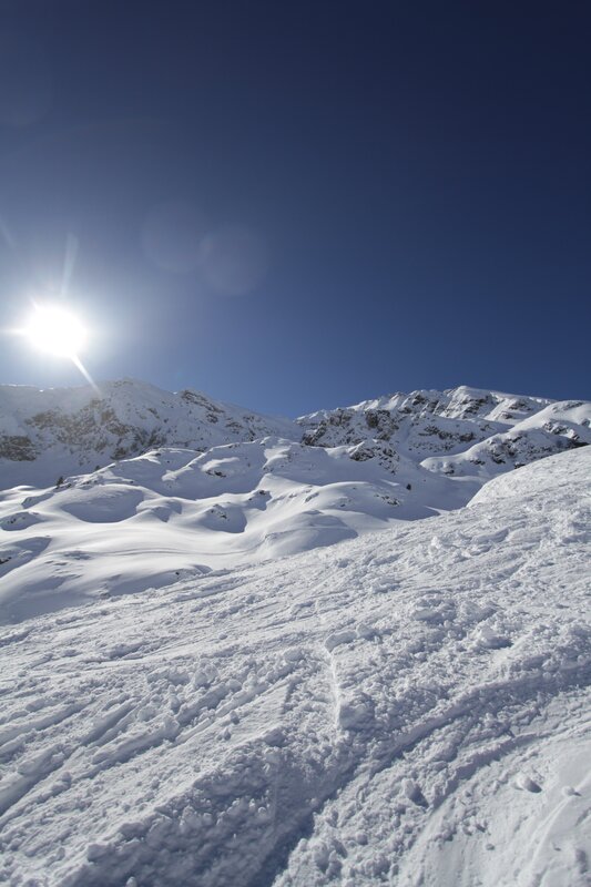 Sunlit snowy mountain peak