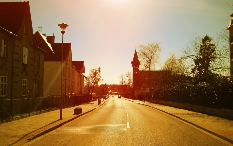 Sunlit street with church tower