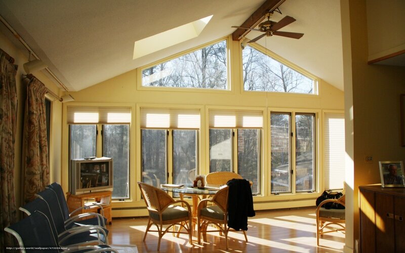 Sunlit sunroom with wicker furniture
