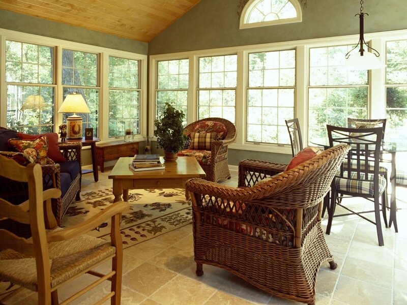 Sunlit sunroom with wicker furniture
