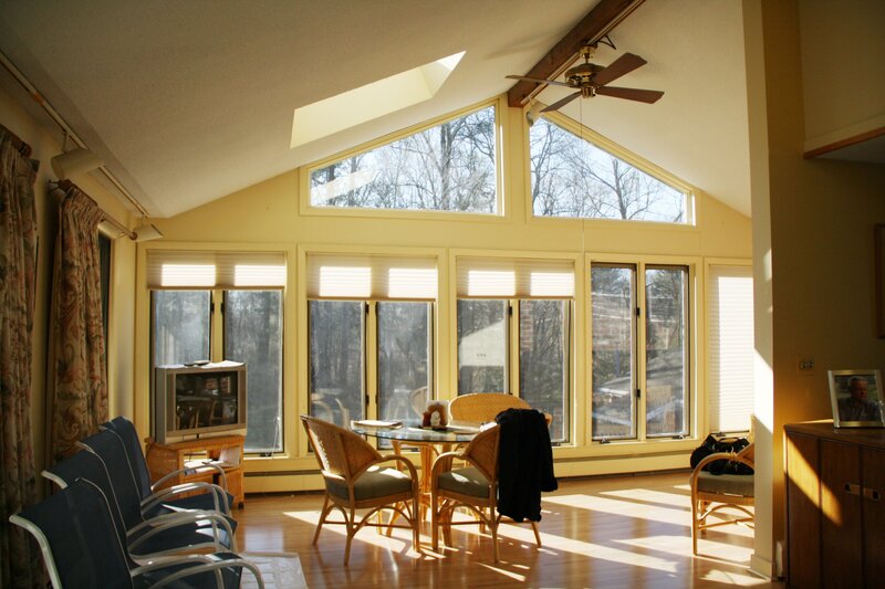 Sunlit sunroom with wicker furniture