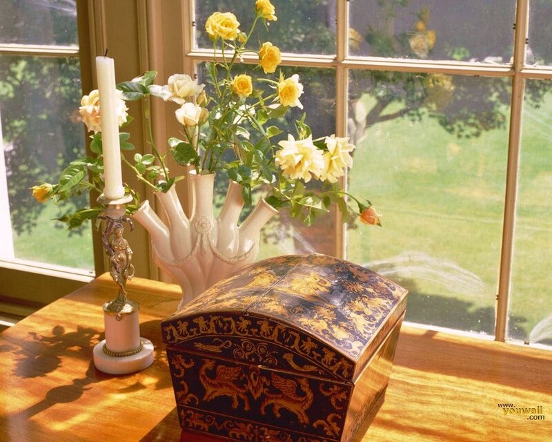Sunlit table with flowers and box