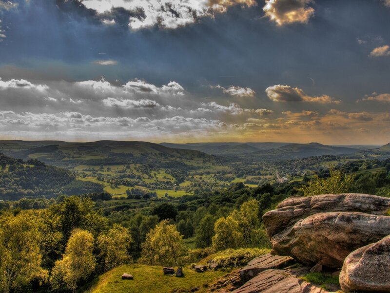 Sunlit valley with rocky outcrop