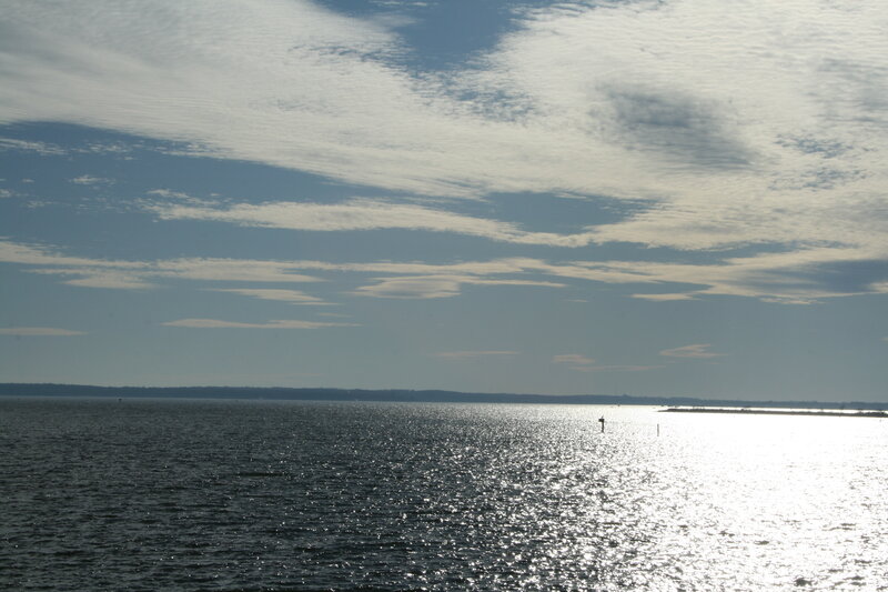 Sunlit water with scattered clouds