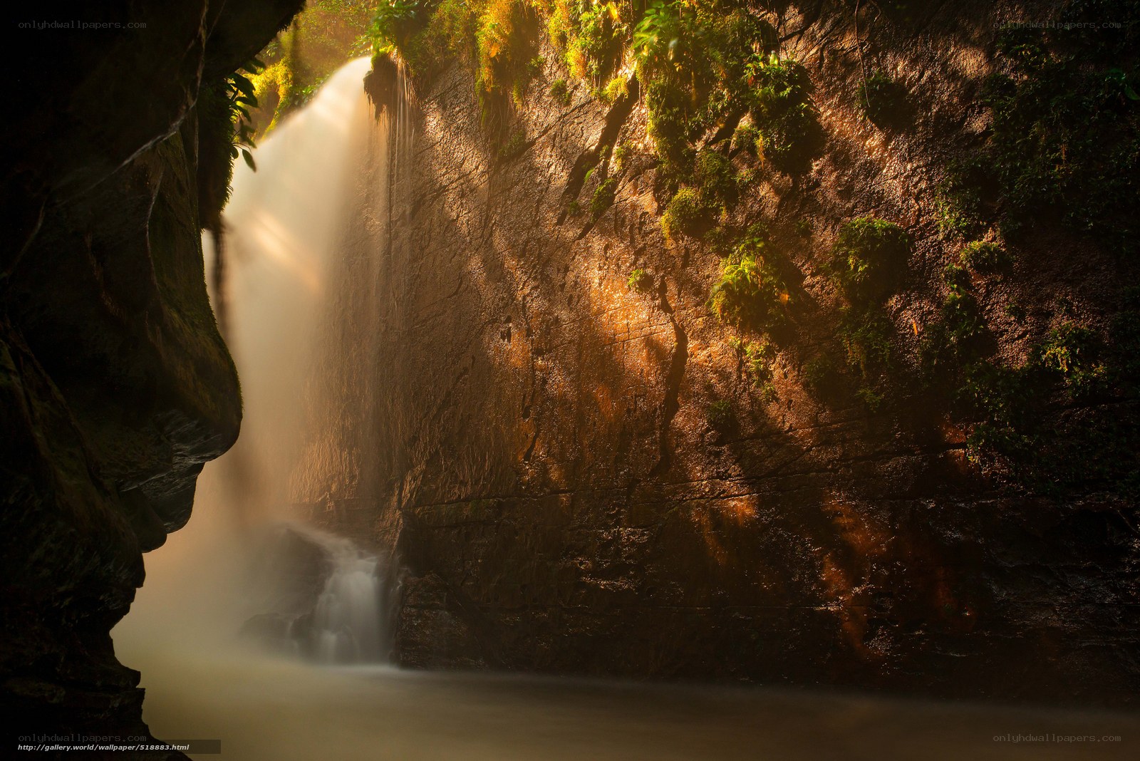 Sunlit waterfall in a canyon