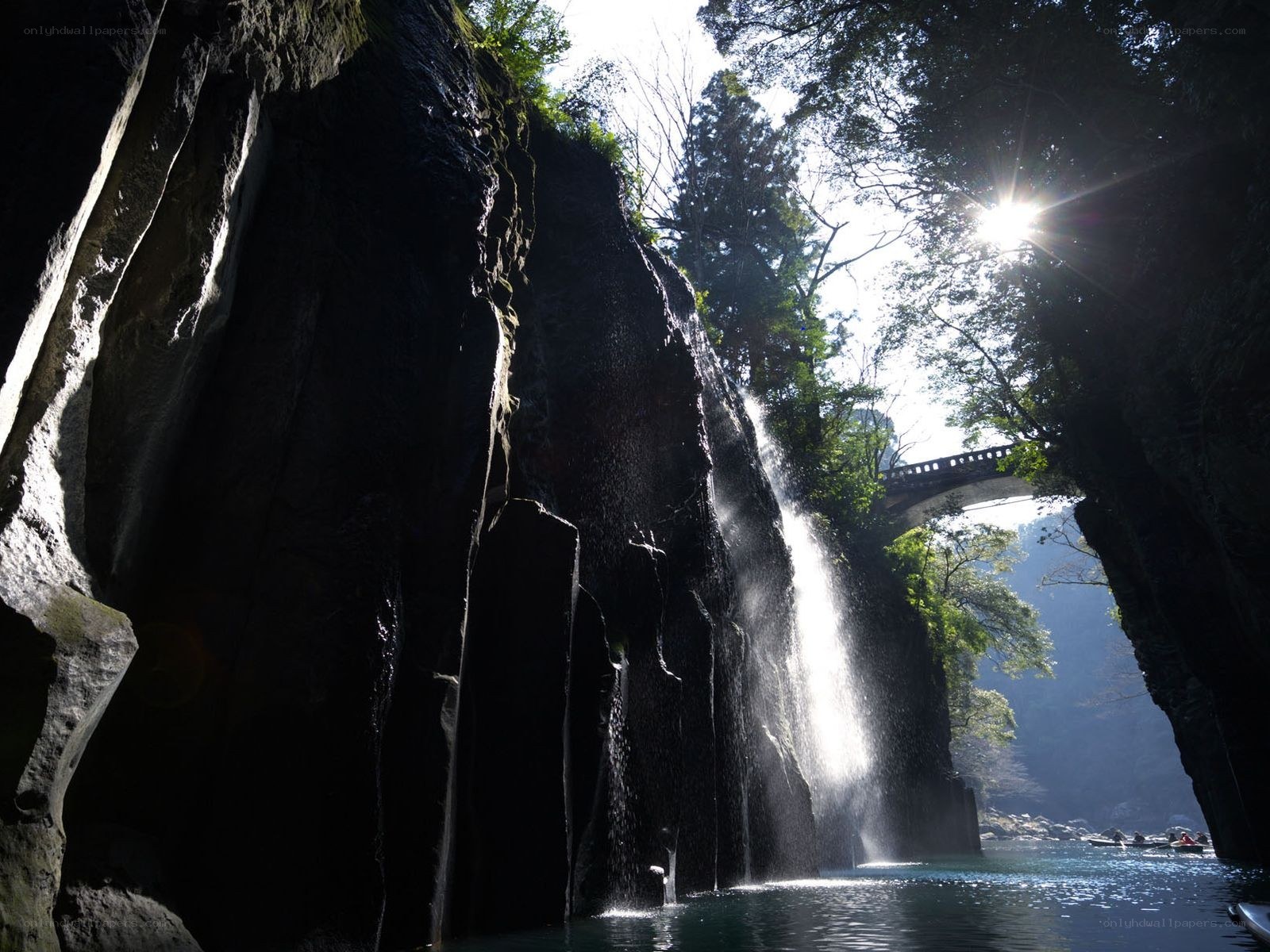 Sunlit waterfall in a canyon