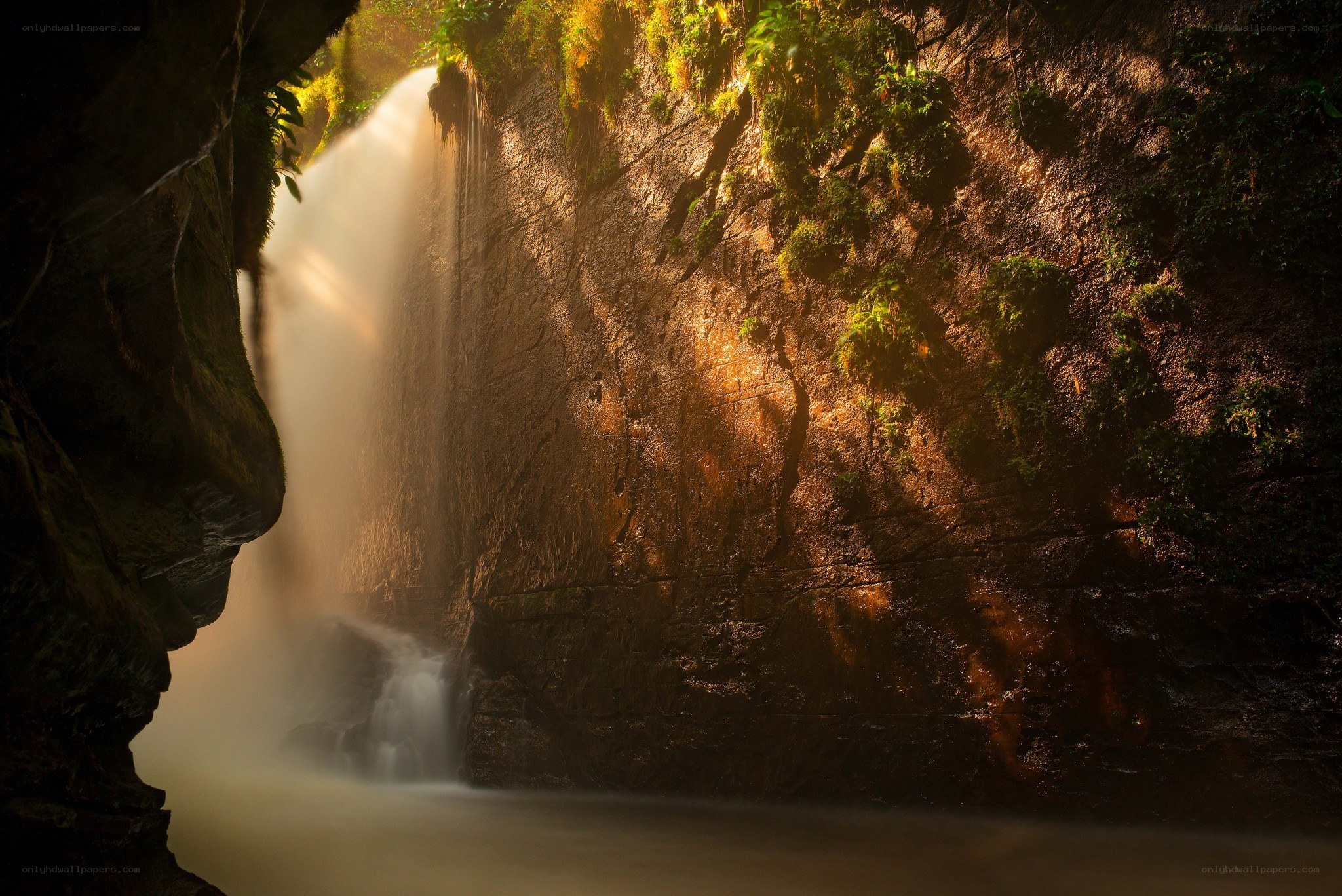 Sunlit waterfall in a canyon