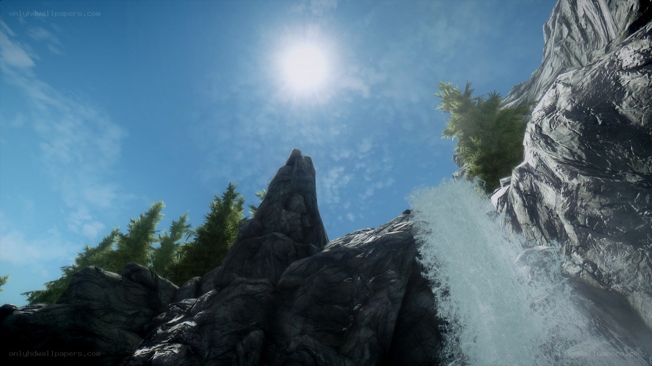 Sunlit waterfall in rocky landscape