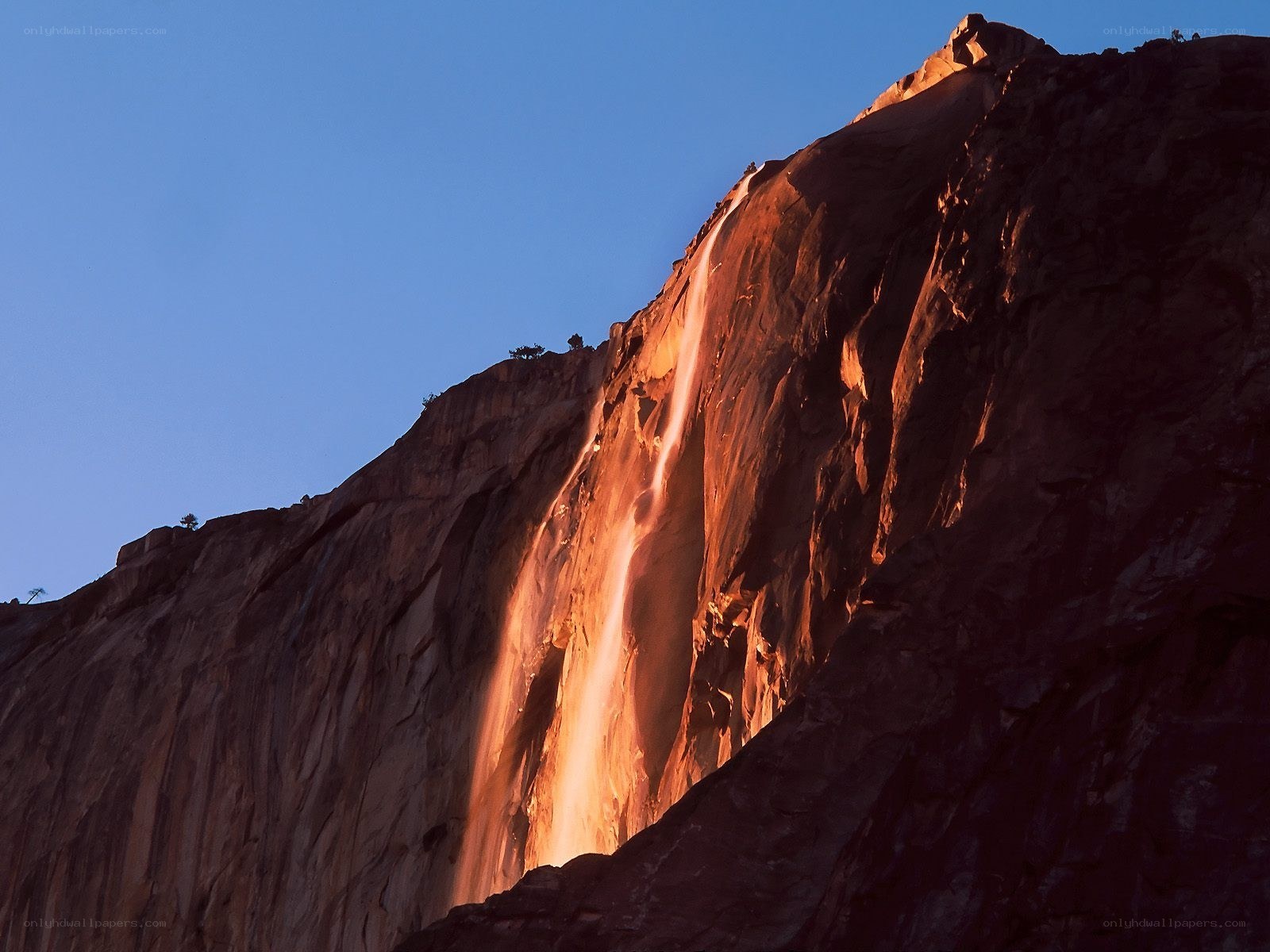 Sunlit waterfall on a cliff