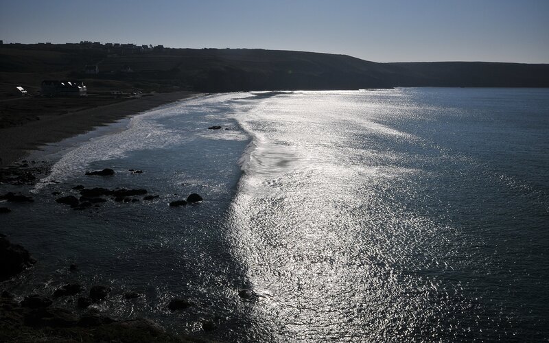 Sunlit waves on a coastal beach