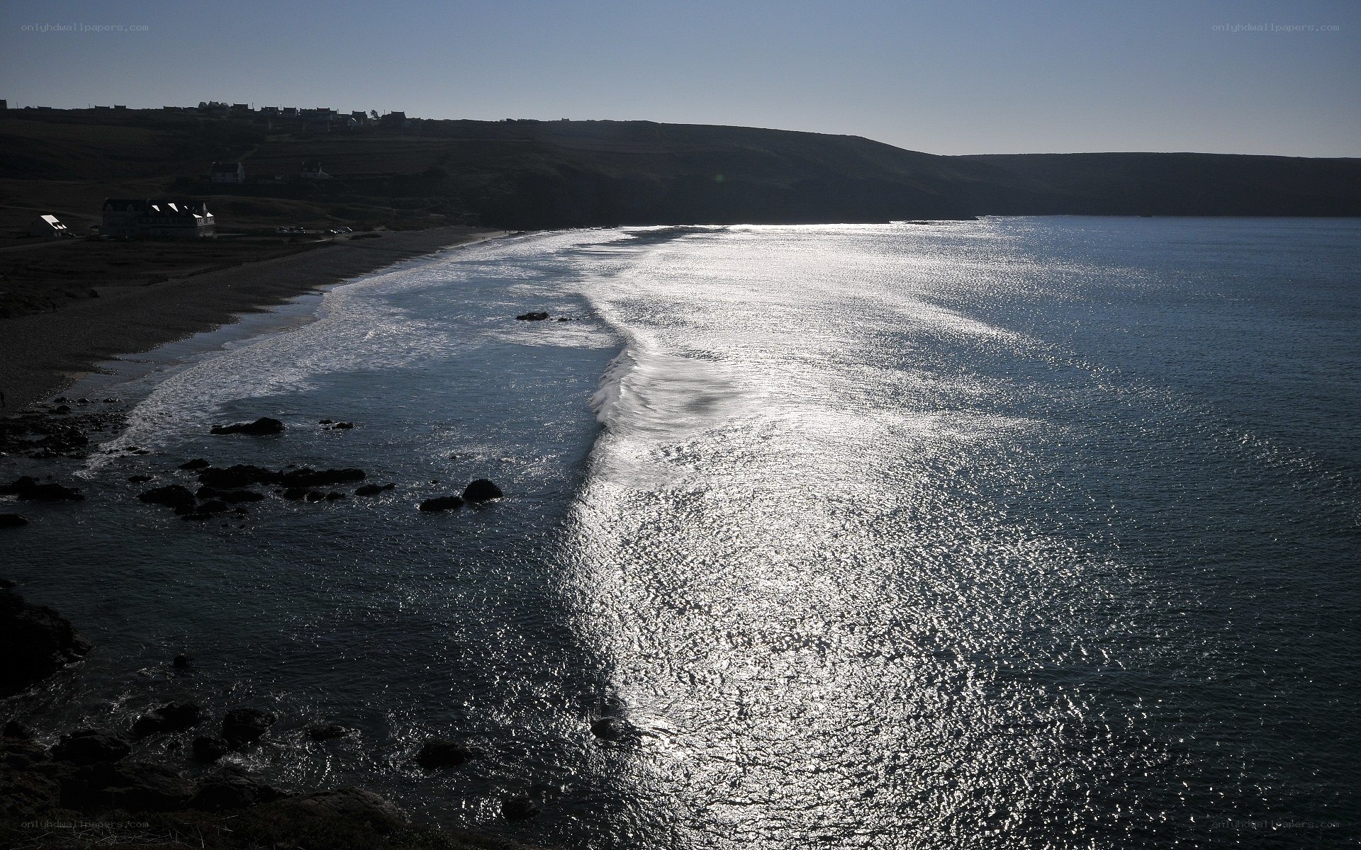 Sunlit waves on a coastal beach