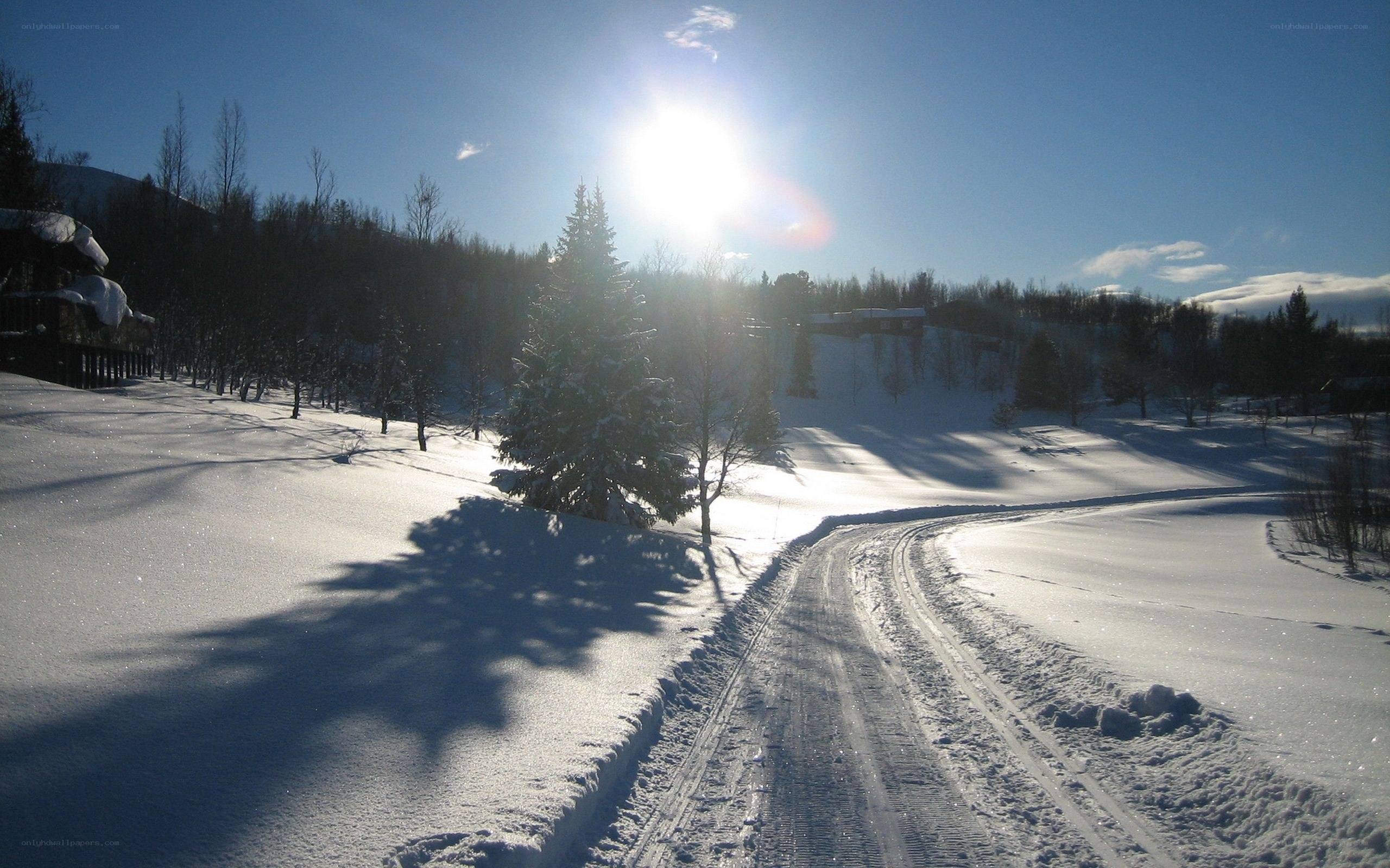 Sunlit winter road with snow