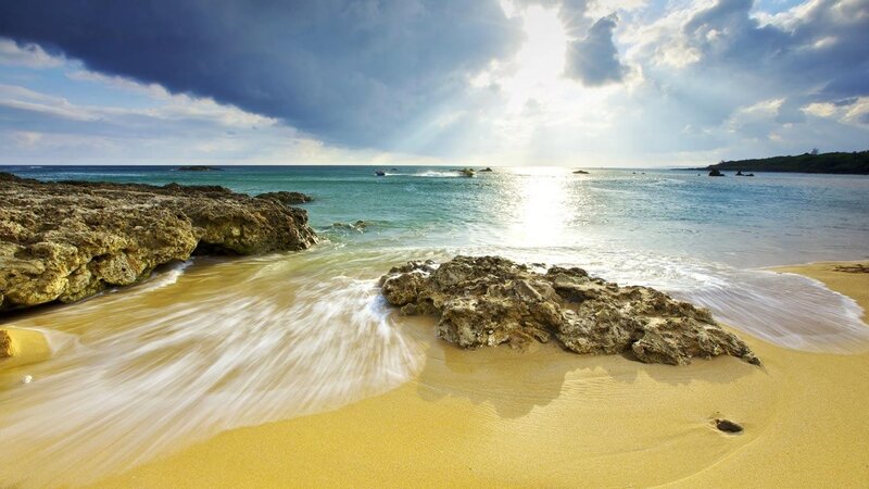 sunny beach with rocky shore
