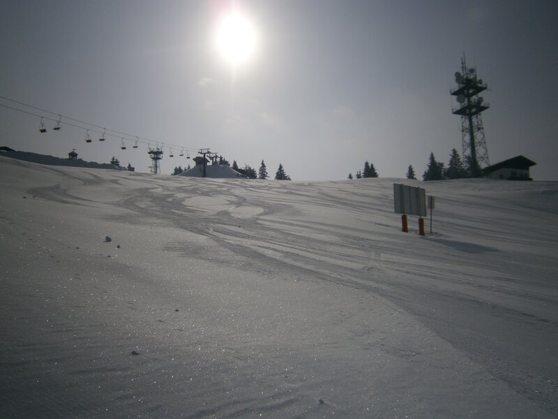 Sunny ski slope with chairlift