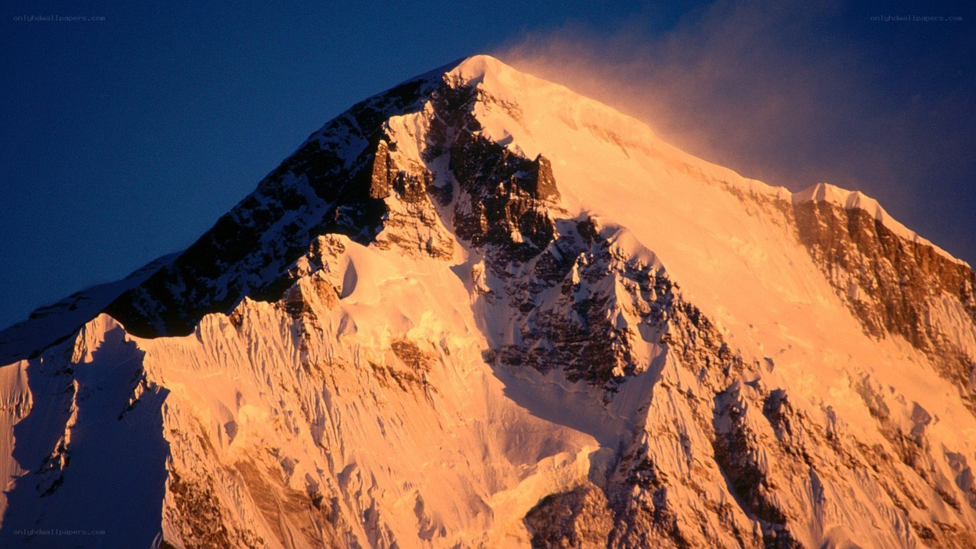 Sunrise on a snow-covered mountain peak