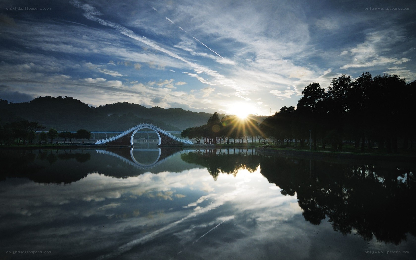 Sunrise over a curved bridge