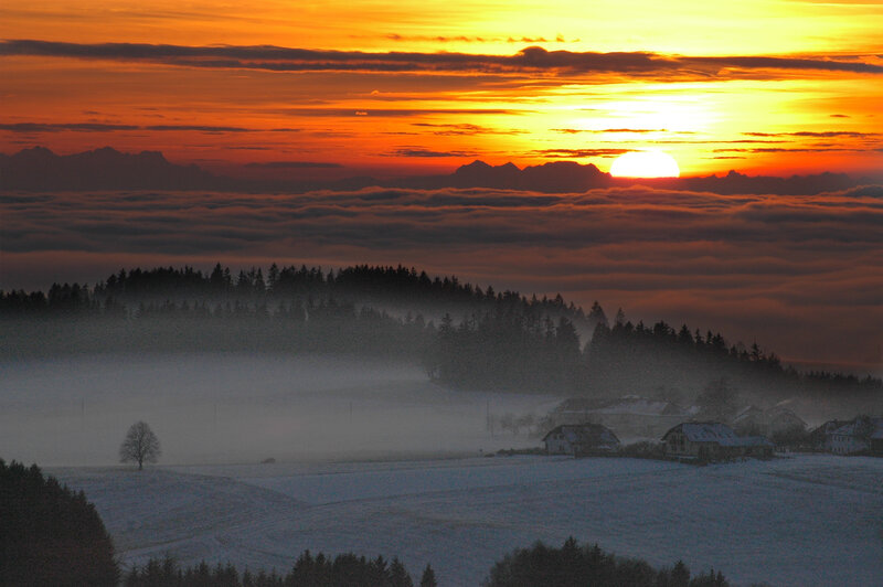 Sunrise over a foggy winter landscape