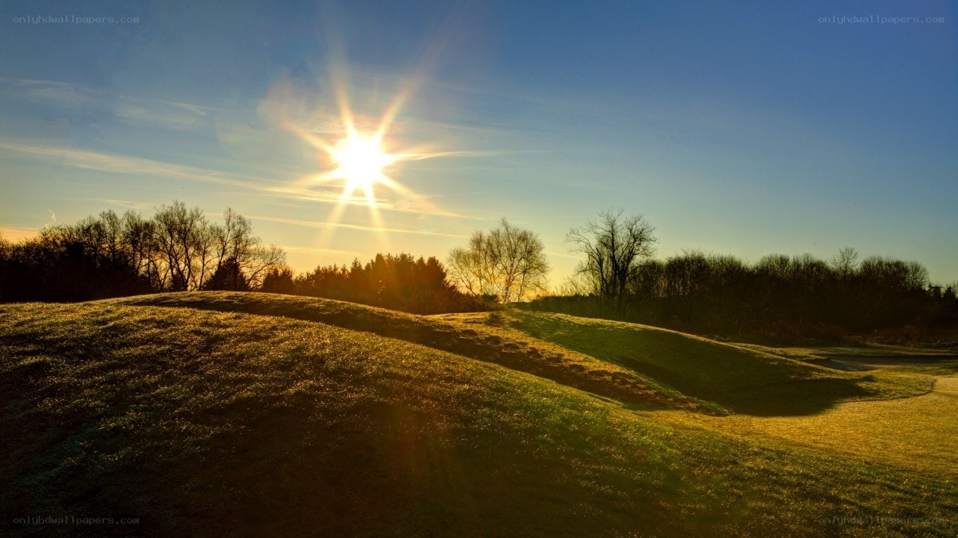 Sunrise over a grassy hill