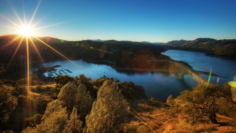 Sunrise over a lake and bridge