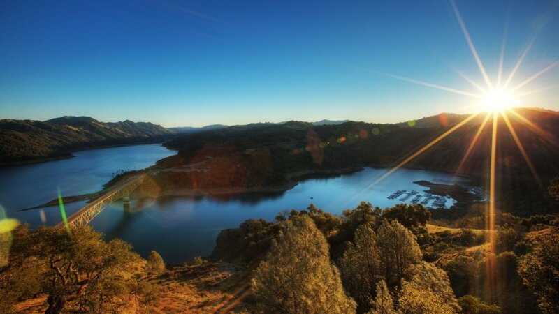 Sunrise over a lake and bridge
