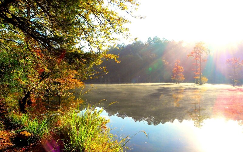 Sunrise over a misty autumn lake