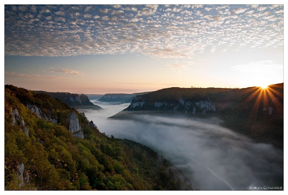 Sunrise over a misty canyon