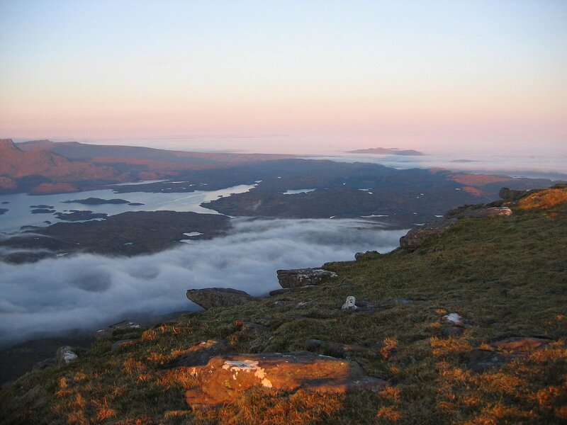 Sunrise over a misty coastal landscape