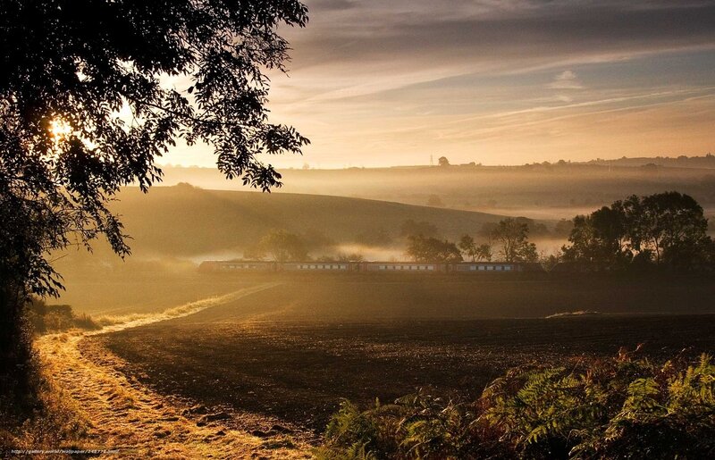 Sunrise over a misty countryside