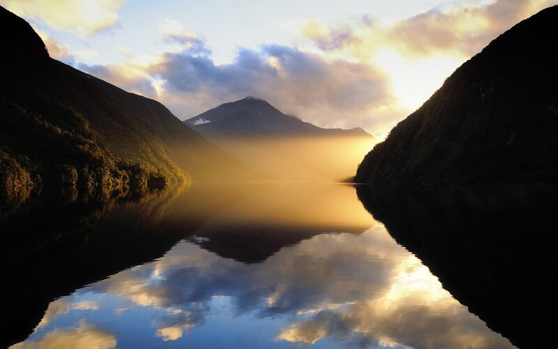 Sunrise over a misty fjord