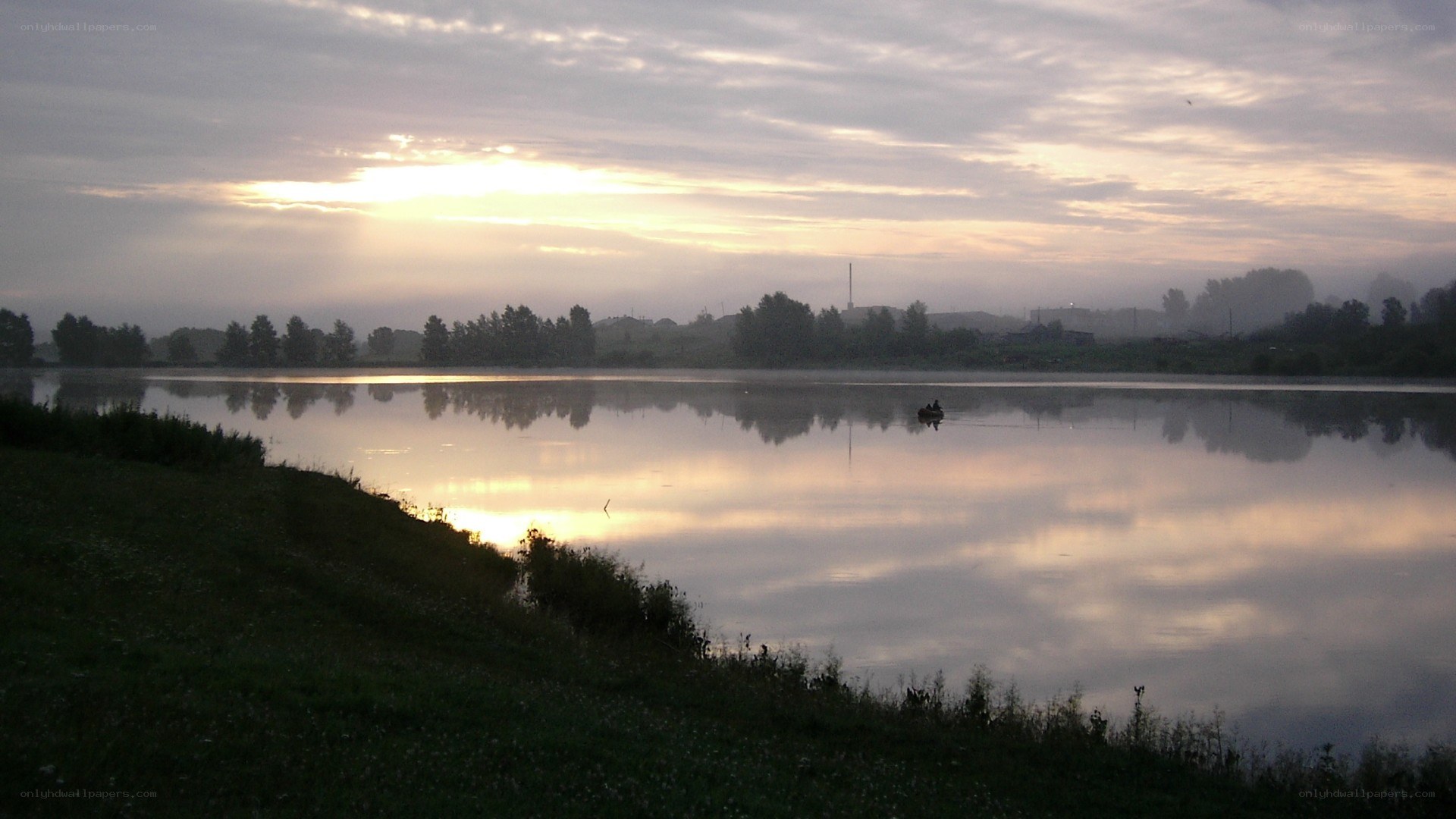 Sunrise over a misty lake
