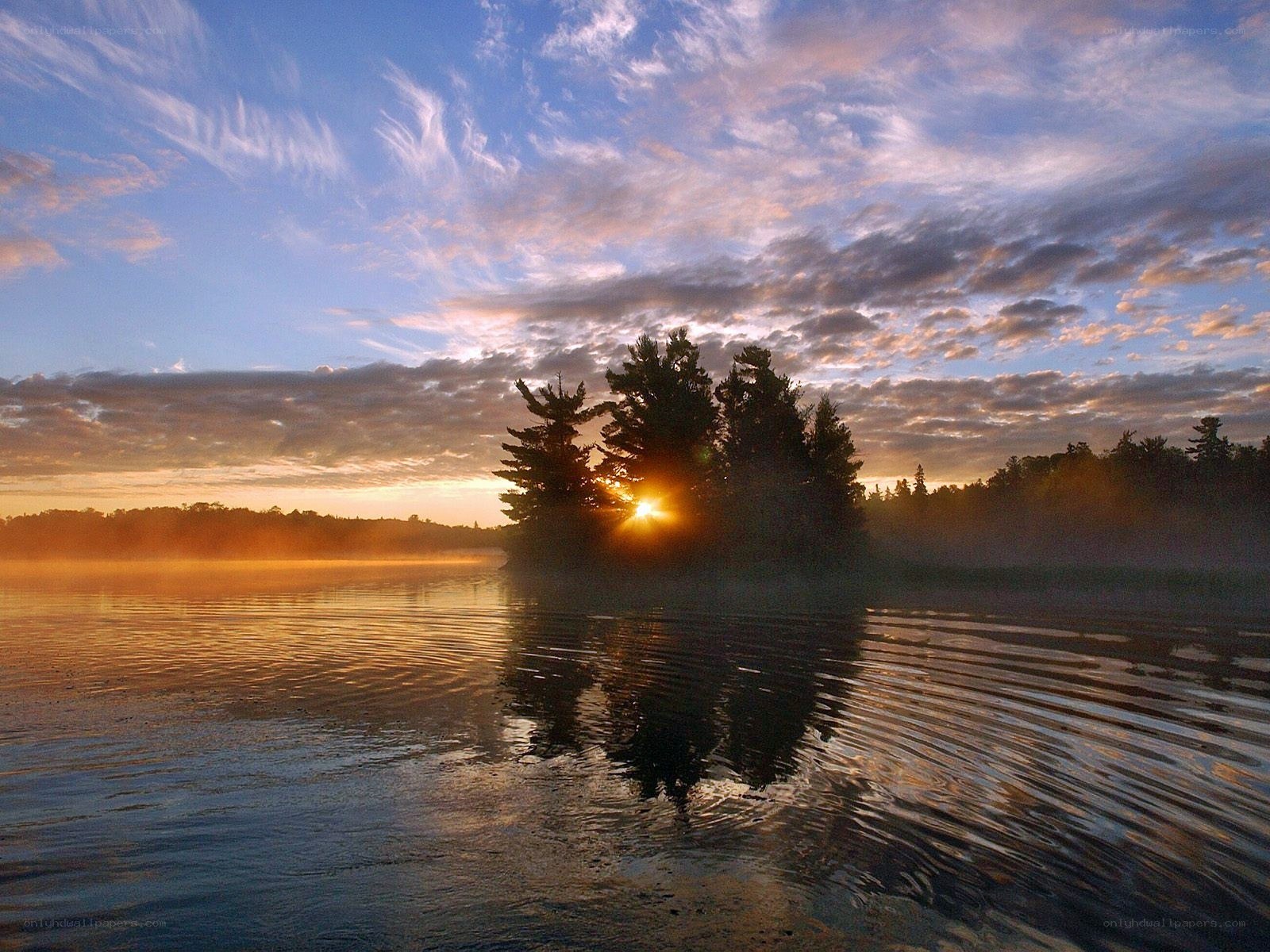 Sunrise over a misty lake