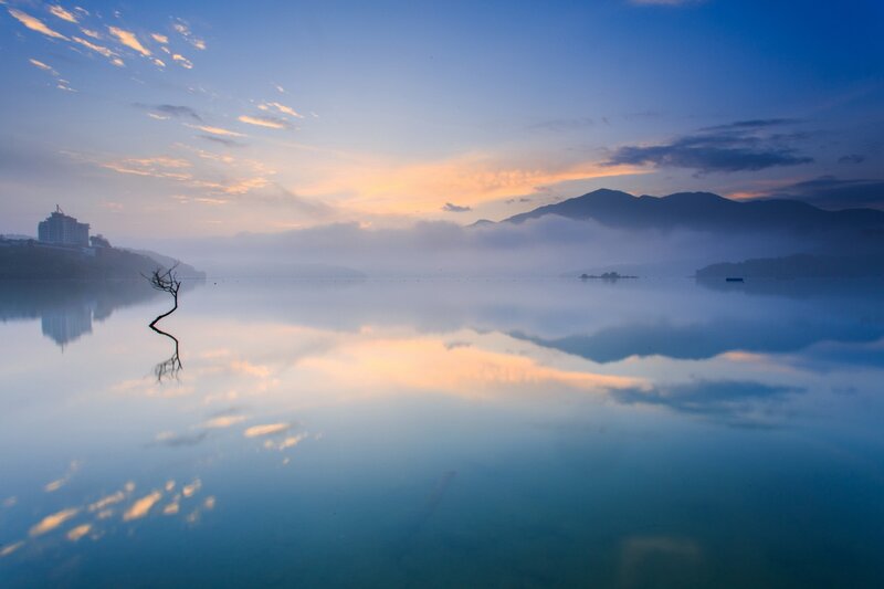Sunrise over a misty lake