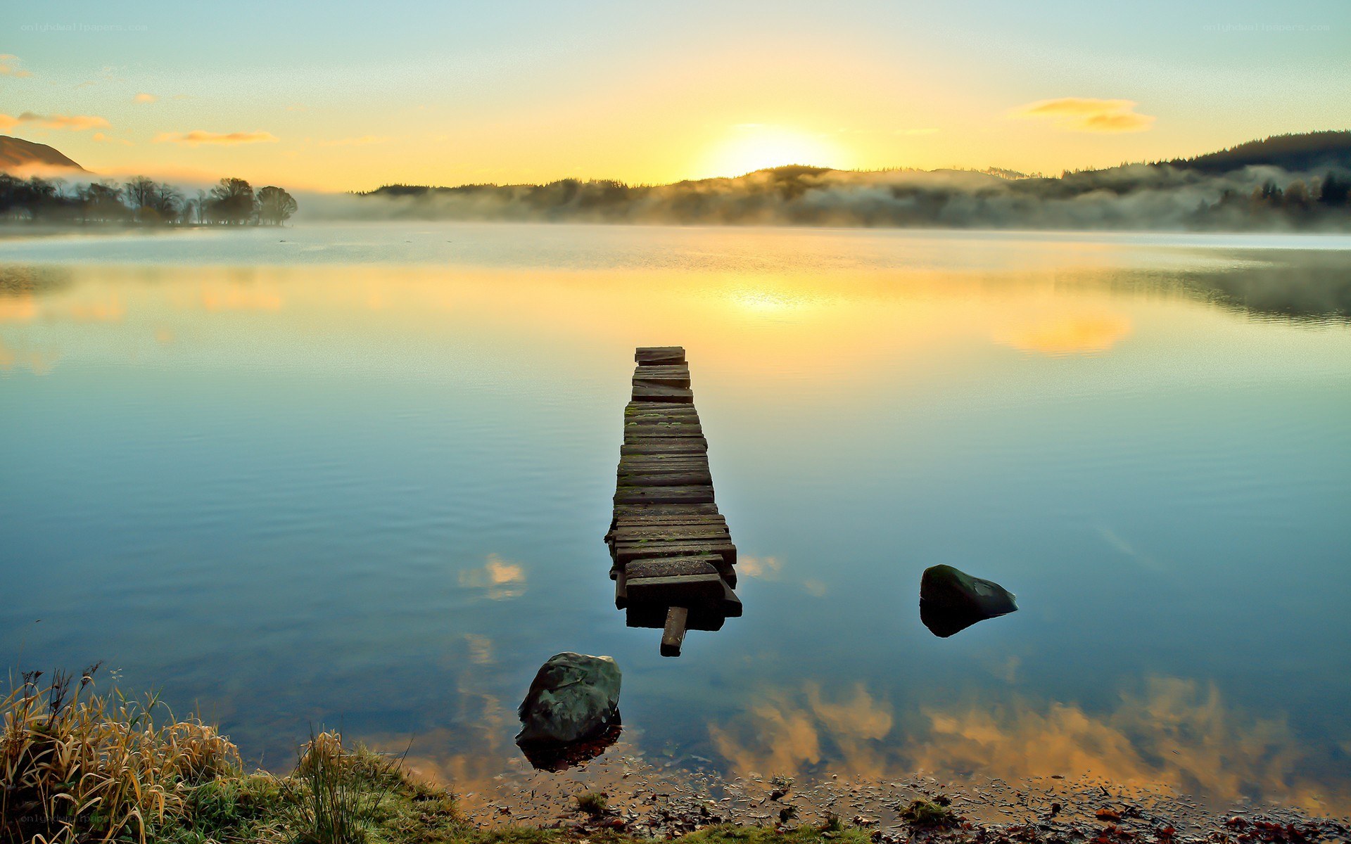 Sunrise over a misty lake