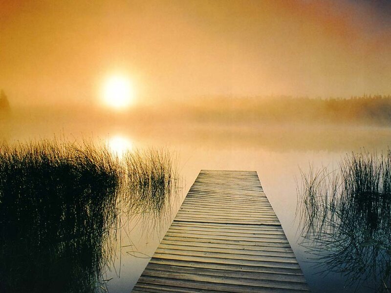 Sunrise over a misty lake